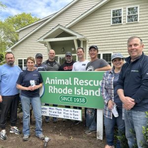 Centreville Bank Volunteers standing next to ARRI sign